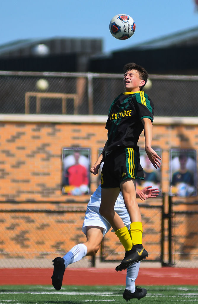 Rock Bridge defender Tristan Greenplate leaps to win possession of a high ball